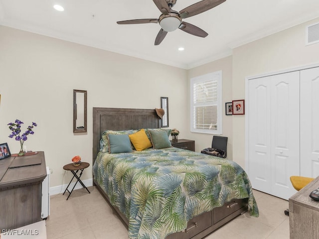 tiled bedroom with ceiling fan, a closet, and ornamental molding