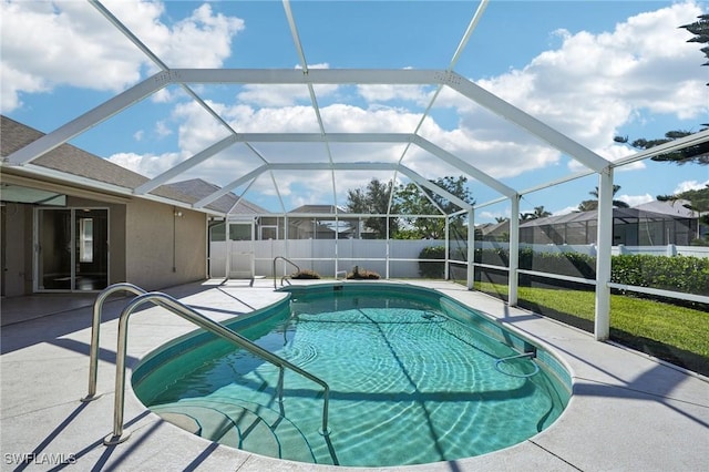 view of pool with a lanai and a patio area