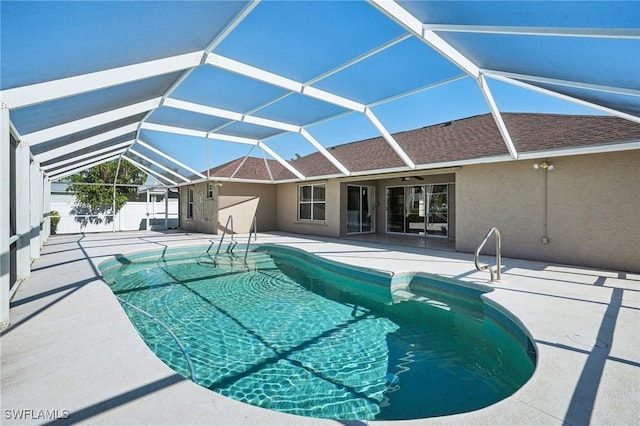 view of pool featuring a lanai, a patio area, and ceiling fan