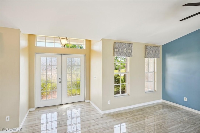 doorway featuring ceiling fan, french doors, and baseboards