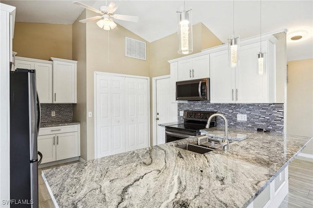 kitchen featuring decorative light fixtures, stainless steel appliances, and white cabinetry