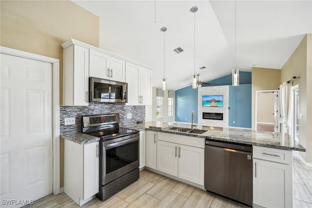 kitchen featuring hanging light fixtures, white cabinetry, sink, and appliances with stainless steel finishes