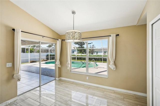 unfurnished dining area featuring lofted ceiling