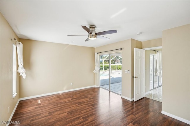 empty room with ceiling fan and dark wood-type flooring