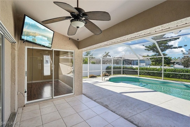 view of swimming pool with a lanai, ceiling fan, and a patio area