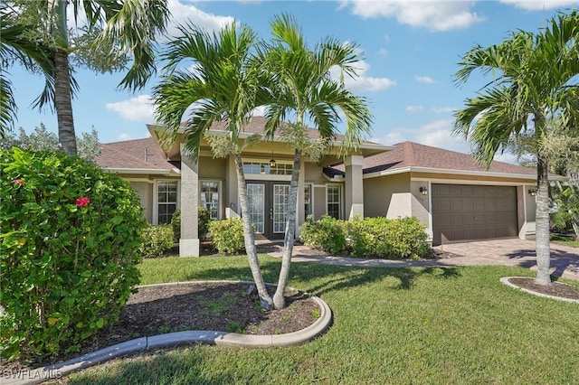 view of front of house featuring a front yard and a garage