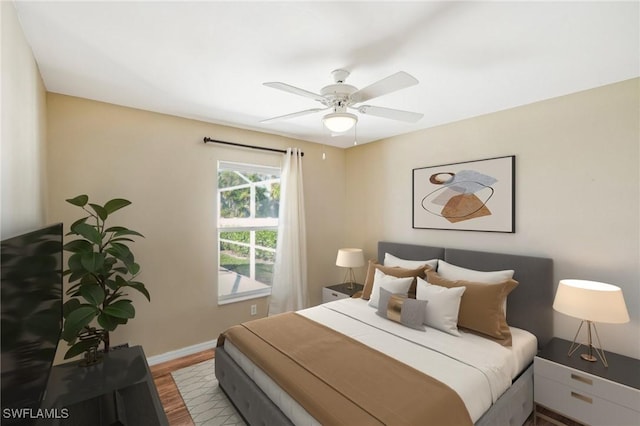 bedroom with ceiling fan and hardwood / wood-style flooring