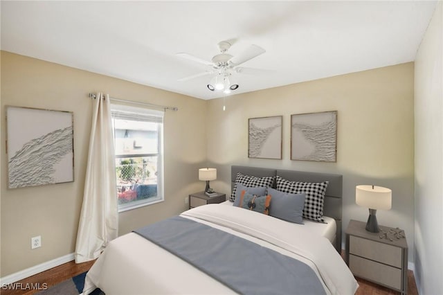 bedroom with ceiling fan and dark wood-type flooring