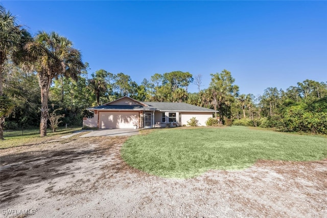 single story home with a front yard and a garage