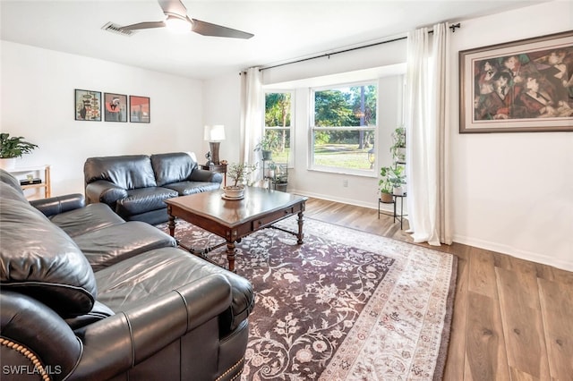 living room featuring ceiling fan and light hardwood / wood-style flooring