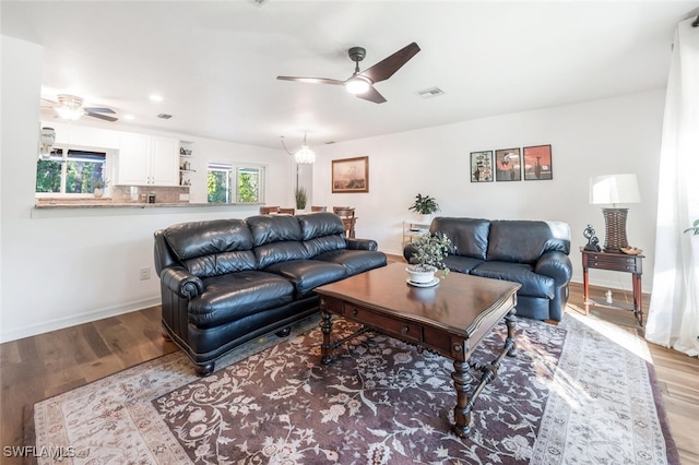 living room with ceiling fan and light hardwood / wood-style floors