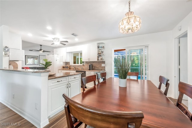 3671 8th Ave SE, Naples, FL 34117 - dining area featuring wood finished floors, ceiling fan, recessed lighting, and a chandelier
