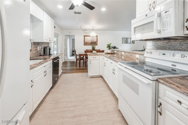 kitchen with tasteful backsplash, kitchen peninsula, white appliances, white cabinets, and light wood-type flooring