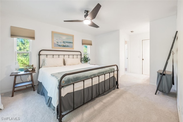 3671 8th Ave SE, Naples, FL 34117 - bedroom featuring multiple windows, light carpet, and ceiling fan