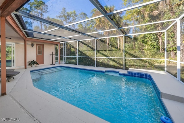 3671 8th Ave SE, Naples, FL 34117 - swimming pool with glass enclosure and a patio area