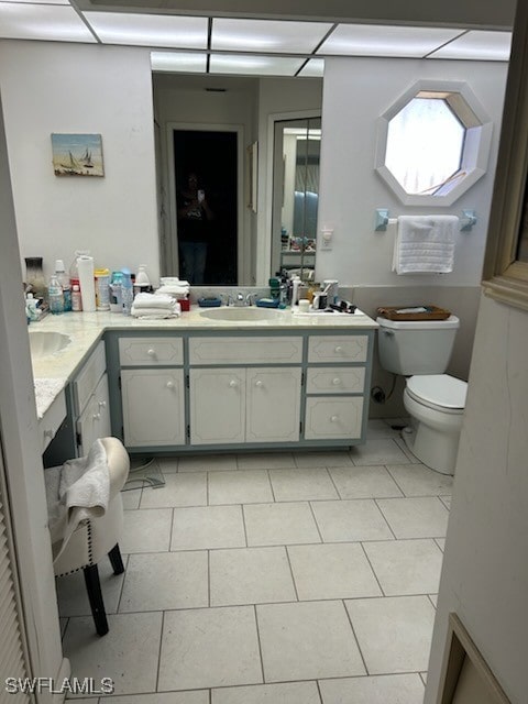 bathroom featuring tile patterned flooring, vanity, and toilet