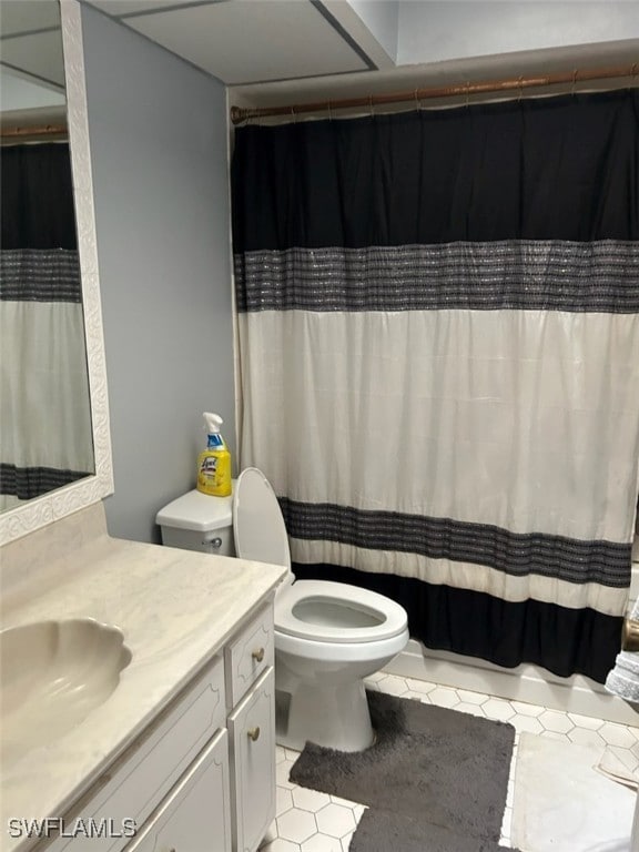 bathroom with tile patterned flooring, vanity, and toilet