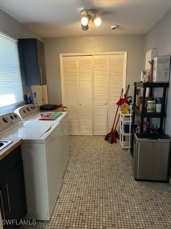 clothes washing area with cabinets and independent washer and dryer