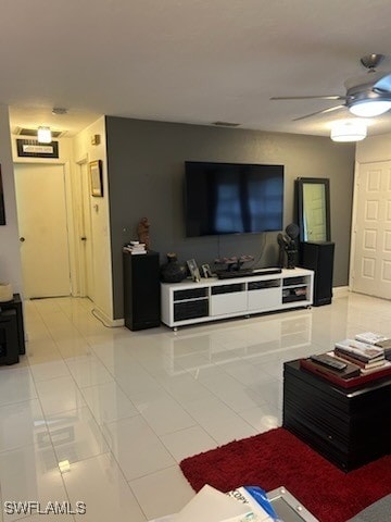 living room featuring light tile patterned floors and ceiling fan