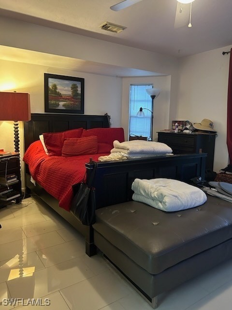 bedroom with ceiling fan and light tile patterned floors