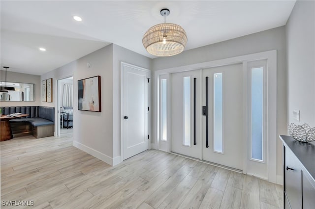 entryway featuring a notable chandelier and light hardwood / wood-style flooring