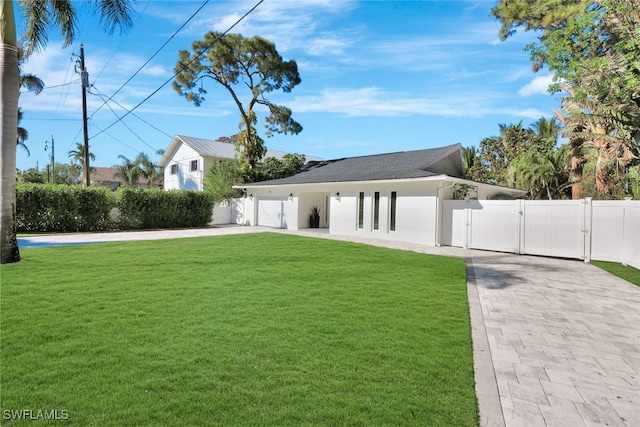 exterior space featuring a garage and a yard