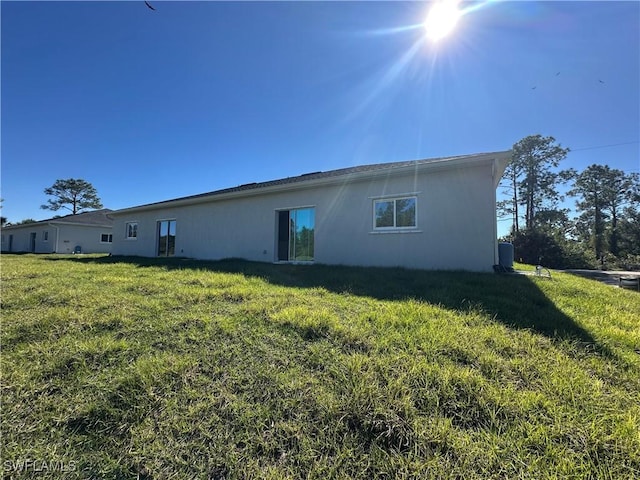 rear view of property with a yard