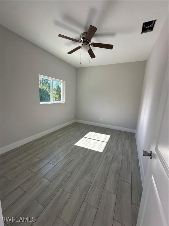 empty room featuring ceiling fan and hardwood / wood-style floors