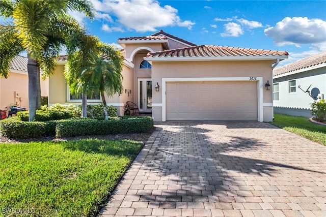 mediterranean / spanish-style house with a garage