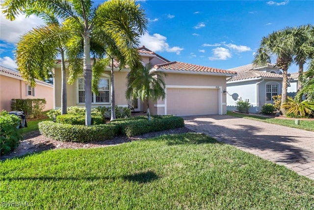 mediterranean / spanish house with a garage and a front yard