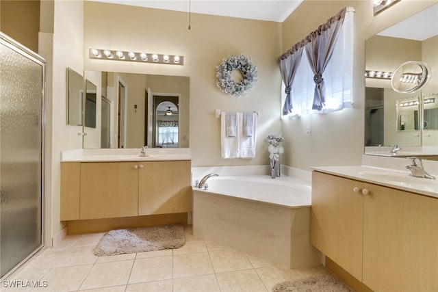 bathroom with tile patterned flooring, vanity, and shower with separate bathtub