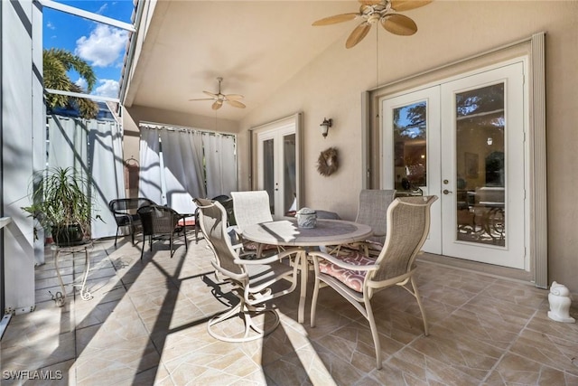 view of patio featuring glass enclosure, ceiling fan, and french doors