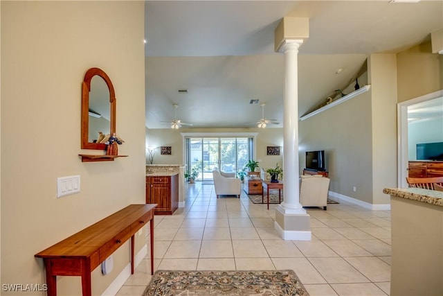 living room with ornate columns, ceiling fan, high vaulted ceiling, and light tile patterned flooring