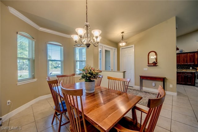 tiled dining area featuring a notable chandelier and ornamental molding