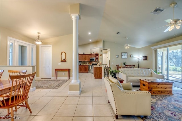 tiled living room with ceiling fan, lofted ceiling, and decorative columns