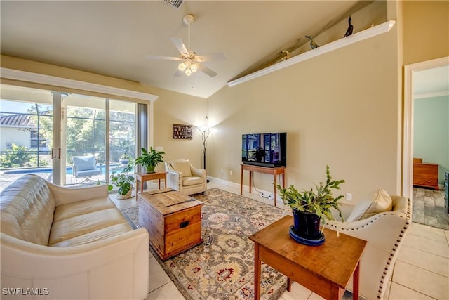 tiled living room with ceiling fan and high vaulted ceiling