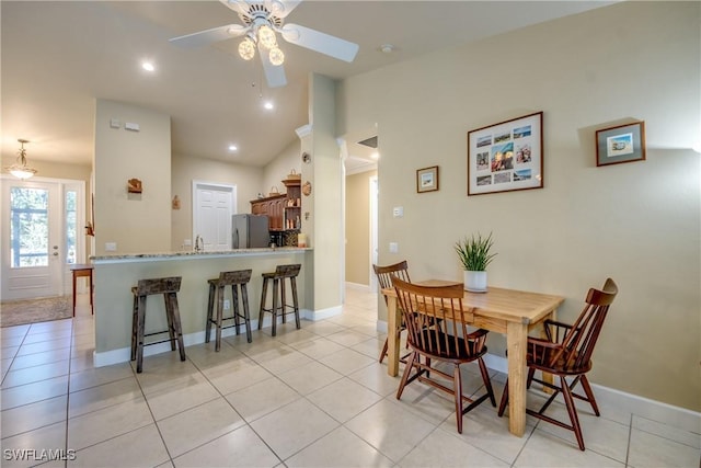 dining area featuring ceiling fan, sink, and light tile patterned floors