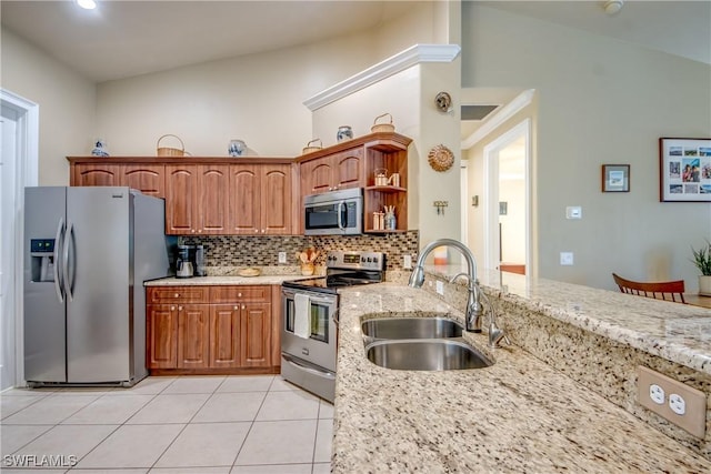 kitchen featuring high vaulted ceiling, sink, light stone countertops, appliances with stainless steel finishes, and tasteful backsplash