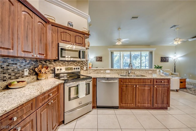 kitchen featuring ceiling fan, sink, stainless steel appliances, kitchen peninsula, and light tile patterned floors