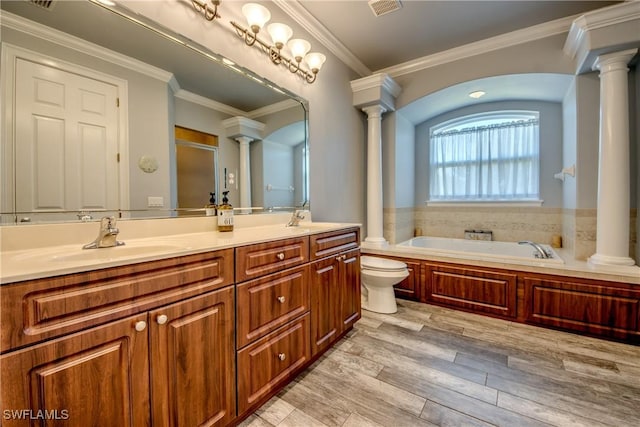 bathroom featuring a tub to relax in, hardwood / wood-style floors, toilet, vanity, and ornamental molding