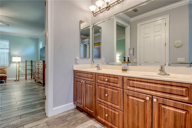 bathroom featuring vanity, wood-type flooring, and ornamental molding