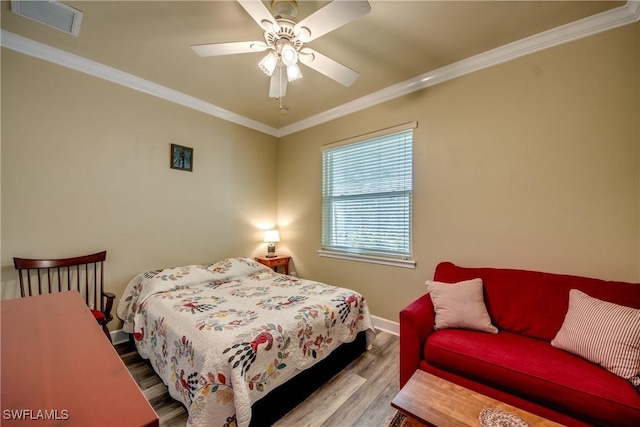 bedroom with light hardwood / wood-style flooring, ceiling fan, and crown molding