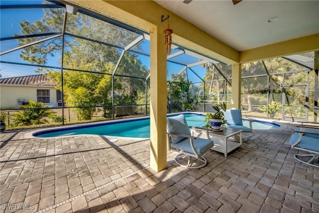 view of swimming pool with glass enclosure and a patio