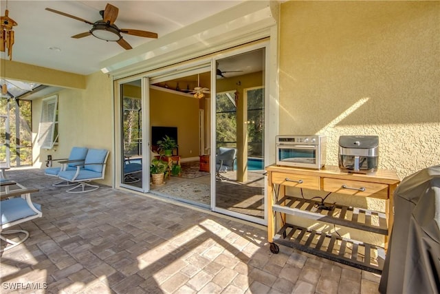 view of patio / terrace with ceiling fan and a grill