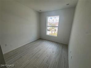 empty room with hardwood / wood-style flooring