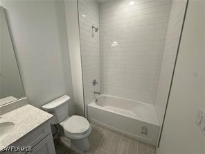 full bathroom with vanity, toilet, and tiled shower / bath