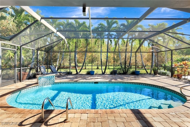 view of pool with a lanai and a patio area