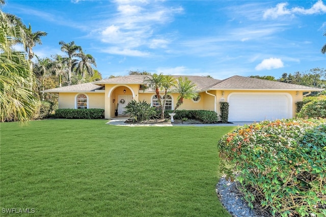 view of front of home featuring a front yard and a garage