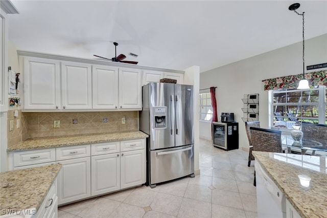 kitchen featuring stainless steel fridge with ice dispenser, backsplash, decorative light fixtures, and white cabinetry