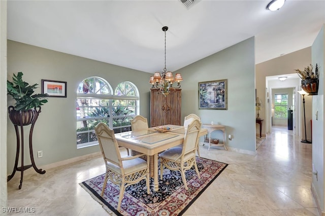 dining area with vaulted ceiling, plenty of natural light, and a notable chandelier